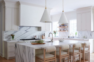 Kitchen - large contemporary u-shaped light wood floor and beige floor kitchen idea in New York with an undermount sink, white cabinets, marble countertops, white backsplash, marble backsplash, stainless steel appliances, an island, white countertops and shaker cabinets
