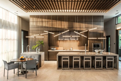 Inspiration for a large contemporary galley limestone floor and beige floor open concept kitchen remodel in Orlando with an undermount sink, flat-panel cabinets, dark wood cabinets, quartzite countertops, brown backsplash, glass tile backsplash, paneled appliances, two islands and gray countertops