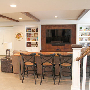 Design ideas for a large bohemian look-out basement in Chicago with carpet, a corner fireplace, a stone fireplace surround, beige floors and grey walls.