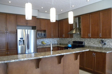 Kitchen - mid-sized transitional l-shaped ceramic tile kitchen idea in Toronto with a double-bowl sink, recessed-panel cabinets, laminate countertops, multicolored backsplash, mosaic tile backsplash, stainless steel appliances, an island and medium tone wood cabinets