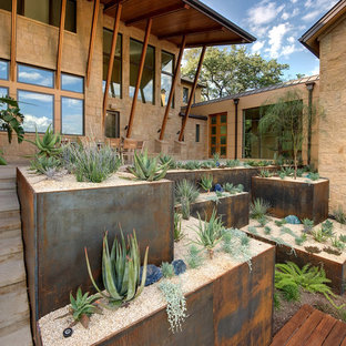 Inspiration for a desert look sloped full sun xeriscape in Austin with concrete pavers.