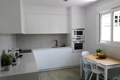 Inspiration for a large contemporary l-shaped eat-in kitchen in Other with flat-panel cabinets.