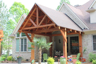 Patio container garden - large craftsman backyard brick patio container garden idea in Charlotte with a roof extension
