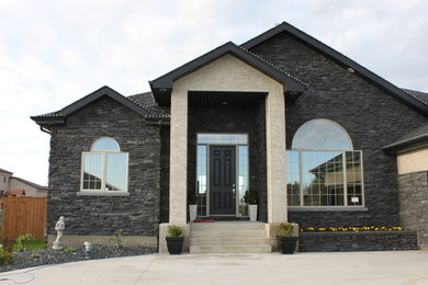 Large elegant multicolored two-story mixed siding exterior home photo in Other with a shingle roof