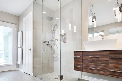 Large modern master bathroom in Ottawa with flat-panel cabinets, dark wood cabinets, a corner shower, grey walls, ceramic floors, a vessel sink, grey floor and a hinged shower door.