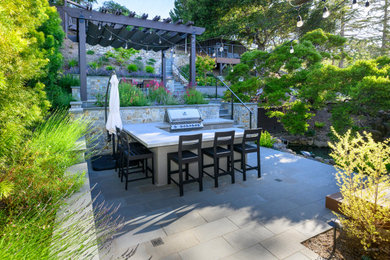 This is an example of a large transitional backyard stone landscaping in San Francisco with a pergola.