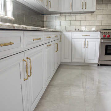 Transitional Kitchen Done in a 2 Tone Color With Integrated Dining Table