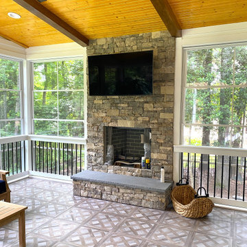 Three-Season Porch with Stone Fireplace and Mounted TV