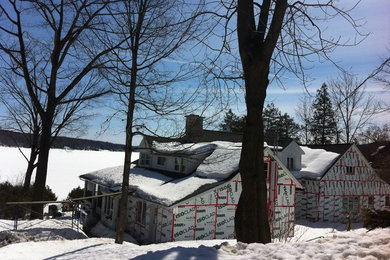 Example of a large classic yellow two-story wood exterior home design in Montreal