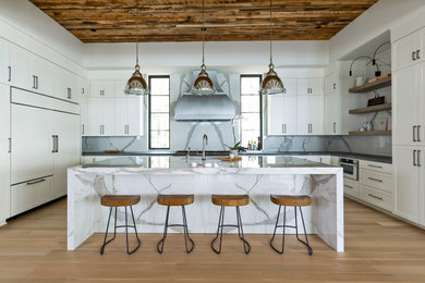 Large trendy u-shaped brown floor, wood ceiling and medium tone wood floor eat-in kitchen photo in Charlotte with an undermount sink, shaker cabinets, white cabinets, quartz countertops, stainless steel appliances, an island, gray backsplash, stone slab backsplash and gray countertops