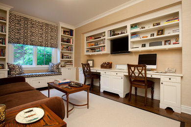 Photo of a large transitional study room in Chicago with beige walls, dark hardwood floors, no fireplace and a built-in desk.