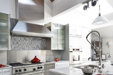 Trendy eat-in kitchen photo in Baltimore with stainless steel appliances, an undermount sink, gray cabinets, granite countertops, multicolored backsplash, stone slab backsplash and flat-panel cabinets