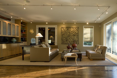 Example of a trendy medium tone wood floor family room design in Chicago with beige walls