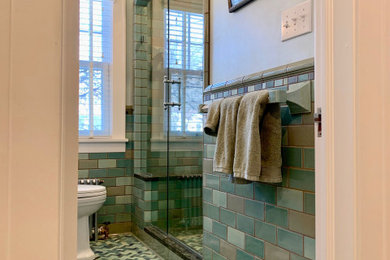 This is an example of a small traditional 3/4 bathroom in Minneapolis with an alcove shower, blue tile, ceramic tile, blue walls, ceramic floors, green floor, a hinged shower door, a shower seat, a single vanity, a one-piece toilet and a pedestal sink.