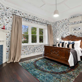 Photo of a mid-sized transitional guest bedroom in Melbourne with a corner fireplace, brown floor, multi-coloured walls, dark hardwood floors and a tile fireplace surround.