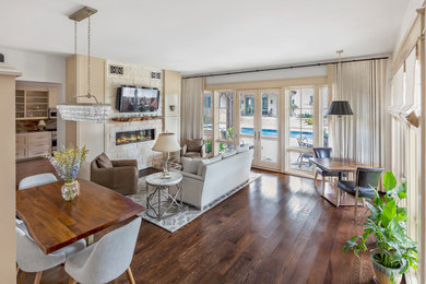 Inspiration for a mid-sized timeless formal and open concept dark wood floor and brown floor living room remodel in Other with beige walls, a standard fireplace, a stone fireplace and a wall-mounted tv