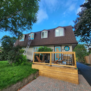 The front porch deck seen from the lawn with the interlock driveway alongside, C