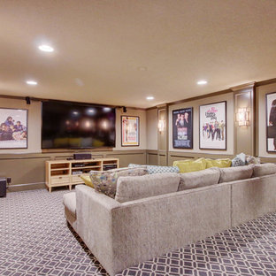 Example of a large transitional enclosed carpeted and multicolored floor home theater design in Kansas City with beige walls and a wall-mounted tv