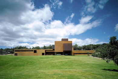 Inspiration for a huge contemporary brown split-level concrete flat roof remodel in Madrid