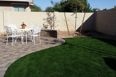 Design ideas for a mid-sized traditional partial sun backyard brick landscaping in Phoenix for spring.