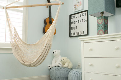 This is an example of a large beach style kids' room for girls in Raleigh with blue walls, carpet and beige floor.