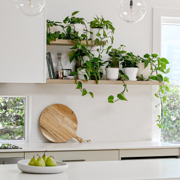Sage green kitchen with window splashback