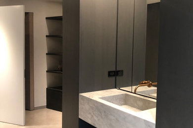 Bathroom - mid-sized contemporary master gray tile and cement tile cement tile floor and gray floor bathroom idea in New York with flat-panel cabinets, gray cabinets, a one-piece toilet, gray walls, an integrated sink, concrete countertops and gray countertops