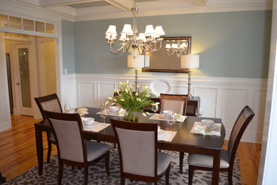 Large traditional separate dining room in Raleigh with light hardwood floors, no fireplace, blue walls and beige floor.