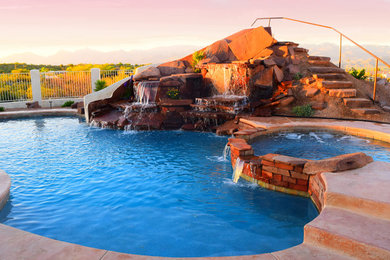 Inspiration for a large backyard kidney-shaped and concrete paver hot tub remodel in Phoenix