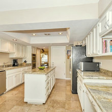White kitchen with travertine floor