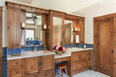 Example of a mid-sized transitional master blue tile gray floor and double-sink bathroom design in Austin with recessed-panel cabinets, an undermount sink, white countertops and a built-in vanity