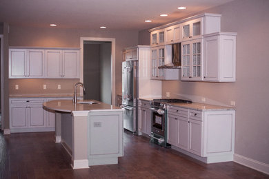 Mid-sized transitional l-shaped dark wood floor and brown floor open concept kitchen photo in Other with a double-bowl sink, recessed-panel cabinets, beige cabinets, granite countertops, stainless steel appliances, an island and beige countertops