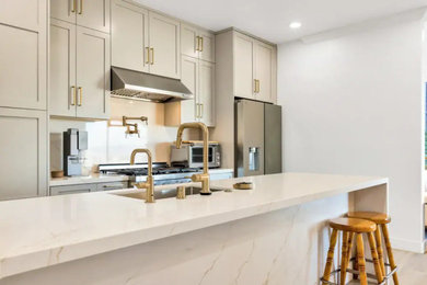 Example of a large minimalist galley light wood floor and beige floor eat-in kitchen design in San Francisco with an undermount sink, shaker cabinets, gray cabinets, quartzite countertops, white backsplash, quartz backsplash, stainless steel appliances, an island and white countertops