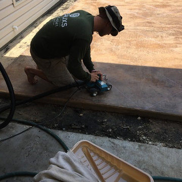Acid stained  concrete being scored in tile pattern