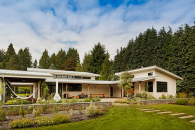 Cottage white one-story exterior home photo in Portland with a shed roof