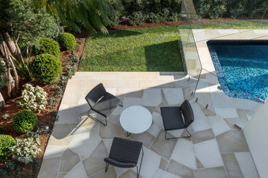 Inspiration for a small contemporary backyard pool in Sydney with with a pool and natural stone pavers.