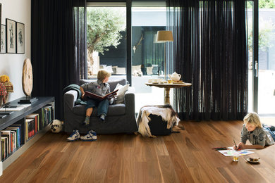Design ideas for a living room in Melbourne with medium hardwood floors.