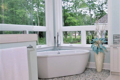 Inspiration for a large traditional ensuite bathroom in Wilmington with recessed-panel cabinets, grey cabinets, a freestanding bath, a built-in shower, beige tiles, pebble tiles, green walls, ceramic flooring, a submerged sink, limestone worktops, beige floors, an open shower and multi-coloured worktops.