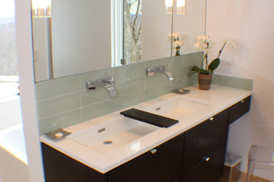 Modern bathroom in Boston with a trough sink, flat-panel cabinets, dark wood cabinets, engineered quartz benchtops, a freestanding tub, a curbless shower, a wall-mount toilet, beige tile and stone tile.