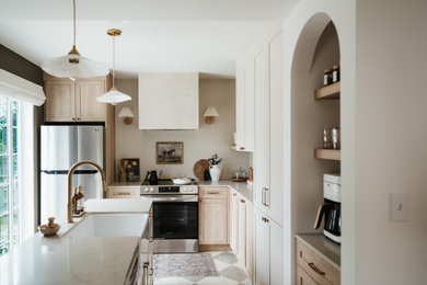 Inspiration for a small l-shaped ceramic tile and multicolored floor eat-in kitchen remodel in Toronto with a farmhouse sink, shaker cabinets, beige cabinets, quartzite countertops, beige backsplash, shiplap backsplash, stainless steel appliances, an island and beige countertops