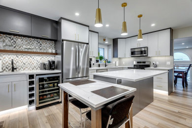 Inspiration for a mid-sized contemporary l-shaped vinyl floor and beige floor kitchen remodel in Edmonton with an undermount sink, flat-panel cabinets, quartzite countertops, subway tile backsplash, an island and white countertops