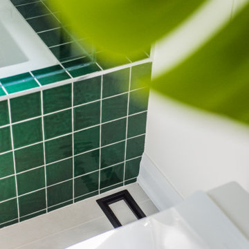 Vibrant Green Ceramic Tiles Bring Life to a Hallway Bathroom