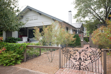 Example of a mid-sized eclectic white one-story mixed siding gable roof design in Houston