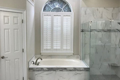Bathroom - huge transitional master gray tile and porcelain tile porcelain tile and gray floor bathroom idea in Jacksonville with shaker cabinets, gray cabinets, a two-piece toilet, gray walls, an undermount sink, granite countertops and gray countertops