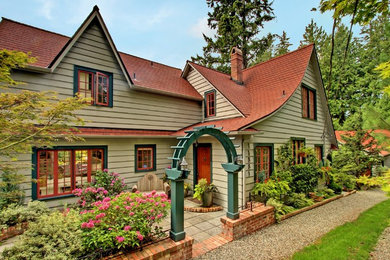 Large cottage beige two-story wood exterior home photo in Seattle