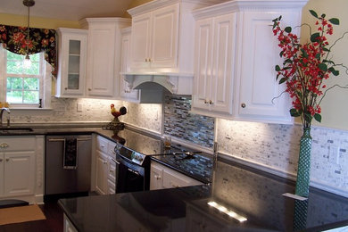 Enclosed kitchen - mid-sized traditional u-shaped dark wood floor enclosed kitchen idea in Other with an undermount sink, raised-panel cabinets, white cabinets, granite countertops, white backsplash, cement tile backsplash, stainless steel appliances and no island