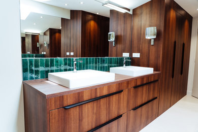 This is an example of a medium sized contemporary shower room bathroom in Bordeaux with beaded cabinets, medium wood cabinets, a hot tub, a walk-in shower, beige tiles, ceramic tiles, beige walls, ceramic flooring, a vessel sink, wooden worktops, beige floors, an open shower, brown worktops, double sinks and a freestanding vanity unit.