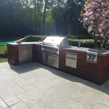 Contemporary L-Shaped Island with Teak wood walls
