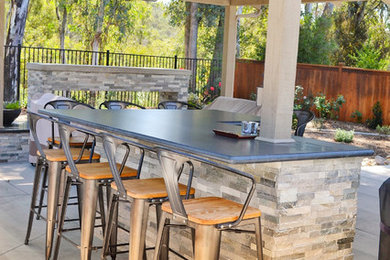 Inspiration for a mid-sized timeless backyard concrete patio remodel in San Diego with a fire pit and a gazebo