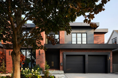 Example of a trendy multicolored two-story brick exterior home design in Ottawa with a mixed material roof and a black roof